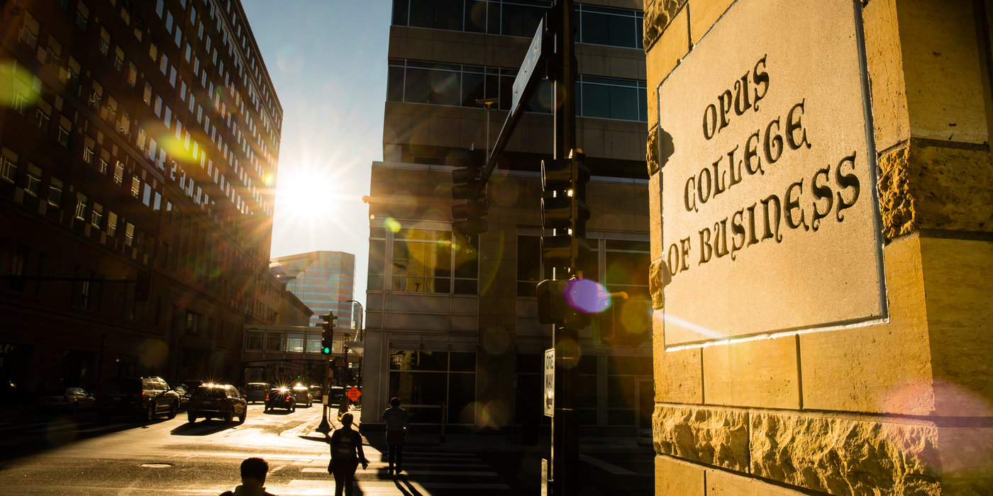 The sun shines on a sign for Opus College of Business on Terrence Murphy Hall in Minneapolis on October 4, 2017.