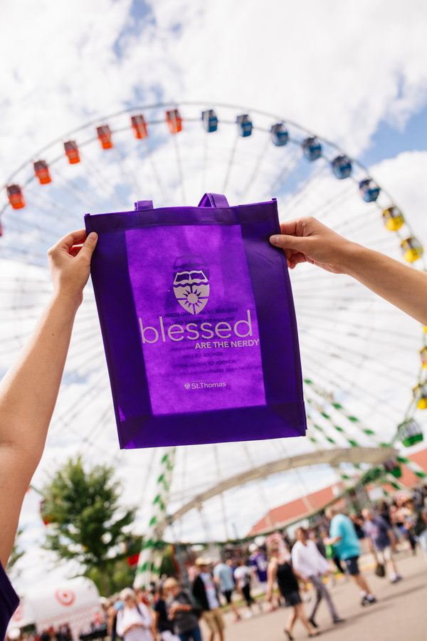 The St. Thomas purple bag in front of the ferris wheel at the Minnesota State Fair.