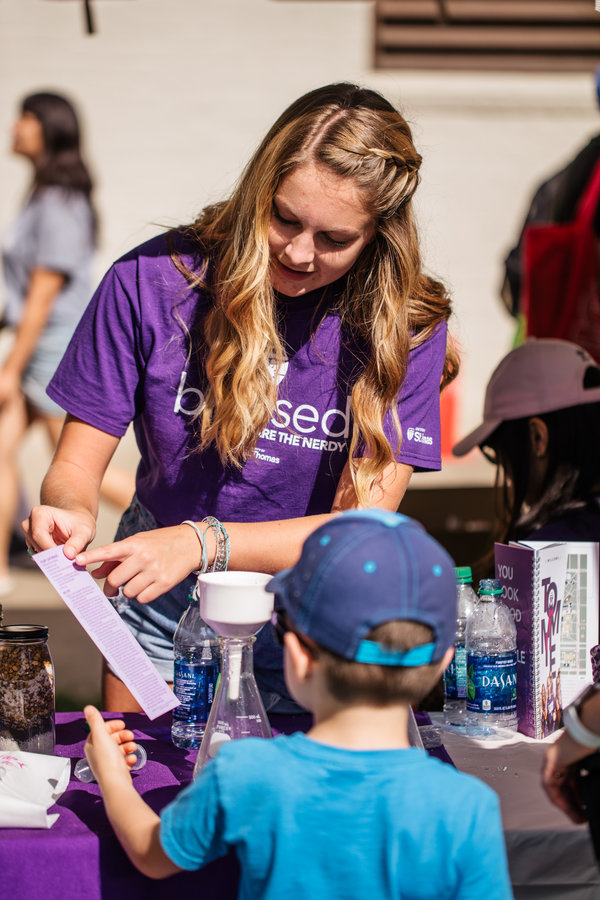 Biochemistry major Sarah Shadle speaks to a young fairgoer on STEM day at the Minnesota State Fair on August 22, 2019 in St. Paul.
