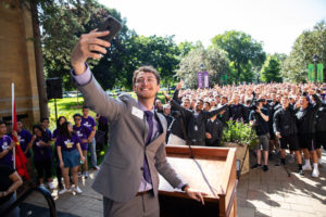 Student government president Logan Monahan takes a selfie during the annual March through the Arches to celebrate the start of the school year and the arrival of a new class of freshmen on campus on September 3, 2019, in St. Paul.