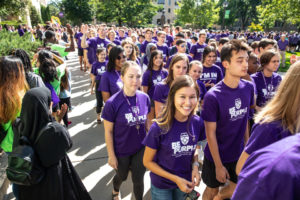 Students walk across the quad during the annual March through the Arches to celebrate the start of the school year and the arrival of a new class of freshmen on campus on September 3, 2019, in St. Paul.