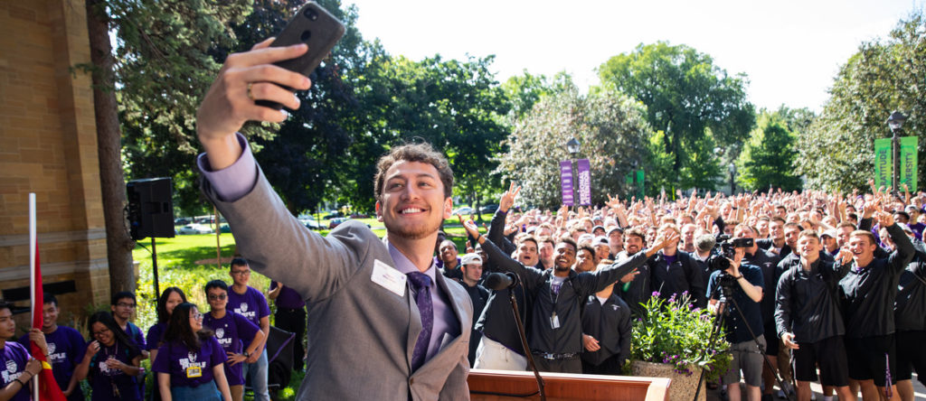 Student government president Logan Monahan takes a selfie during the annual March through the Arches to celebrate the start of the school year.