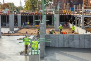 Crews work on the cement pad on the first year residence hall construction project on north campus on October 18, 2019, in St. Paul.