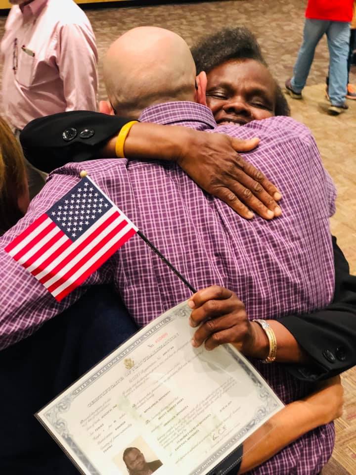 Harriet get a hug after receiving her citizenship.