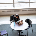 A student studies at a table in the Anderson Student Center atrium. Mark Brown/University of St. Thomas