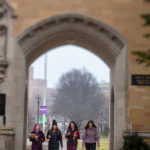 Students walk through The Arches with Birdie Cunningham, associate director of Health and Wellness, on a foggy morning.