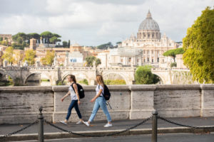 Students walk together to class from the Bernardi campus building in Rome, Italy with St. Peter’s Basilica visible in the background. on October 16, 2019. (Students pictured: Lauren Degn, Isabelle Spooner)