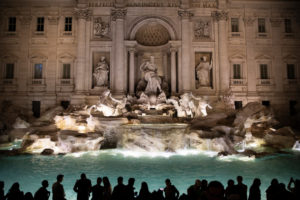 Tourists gather around the Trevi Fountain at night in Rome, Italy on October 16, 2019.