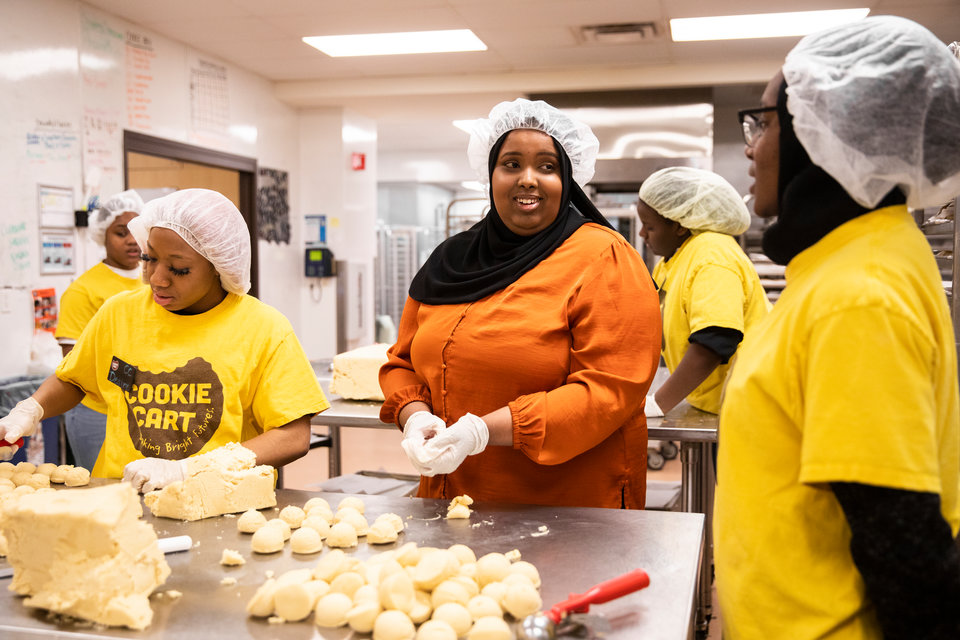St. Thomas senior Sarah Isse, center, works alongside teen youth, volunteering at Cookie Cart, a bakery and non-profit that employs teenagers, providing them with leadership skills and work experience, in Minneapolis on December 19, 2019.