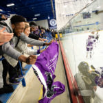 Fans cheer on the Tommies during a women's hockey game. Mark Brown/University of St. Thomas