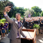 Student government president Logan Monahan takes a selfie during the annual March Through the Arches celebration. Mark Brown/University of St. Thomas