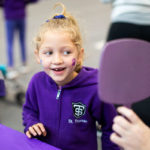 A young Tommie gets her face painted during the Purple on the Plaza event. Liam James Doyle/University of St. Thomas