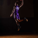 Elijah Hannah leaps during a photoshoot for the UST Men’s Basketball schedule poster. Mark Brown/University of St. Thomas