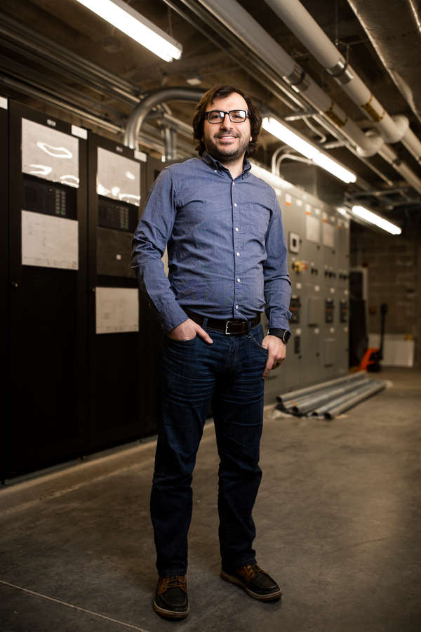 Engineering professor Mahmoud Kabalan stands for a portrait amongst equipment related to the new mircogrid research and testing facility in the Facilities and Design Center in St. Paul on January 30, 2020.