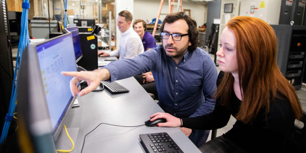 Engineering professor Mahmoud Kabalan, center, engages with a student, using equipment related to the new mircogrid research and testing facility in the Facilities and Design Center in St. Paul on January 30, 2020.