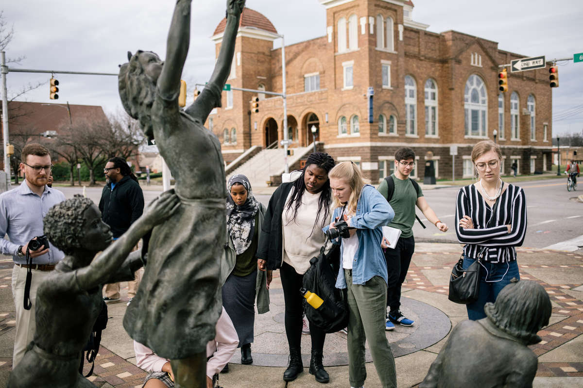 Students look at Four Spirits sculpture in Kelly Ingram Park, across from the 16th Street Baptist Church in Birmingham, Alabama. The statue commemorates the four young victims of a bombing that occurred at the church in 1963.