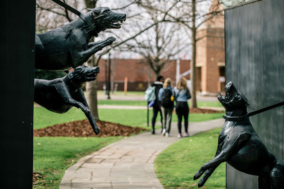 Students walk past a sculptural installation in Birmingham's Kelly Park depicting the dogs law enforcement agencies used to break up peaceful protests.