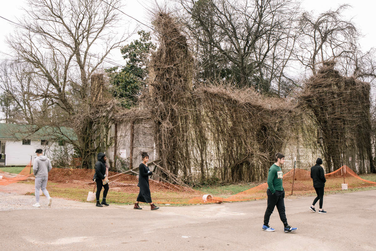 Students walk past the remnants of Bryant's Grocery and Meat Market in Greenwood, Mississippi, where Emmett Till’s alleged interaction with a white woman eventually cost the 14-year-old Chicago boy his life.
