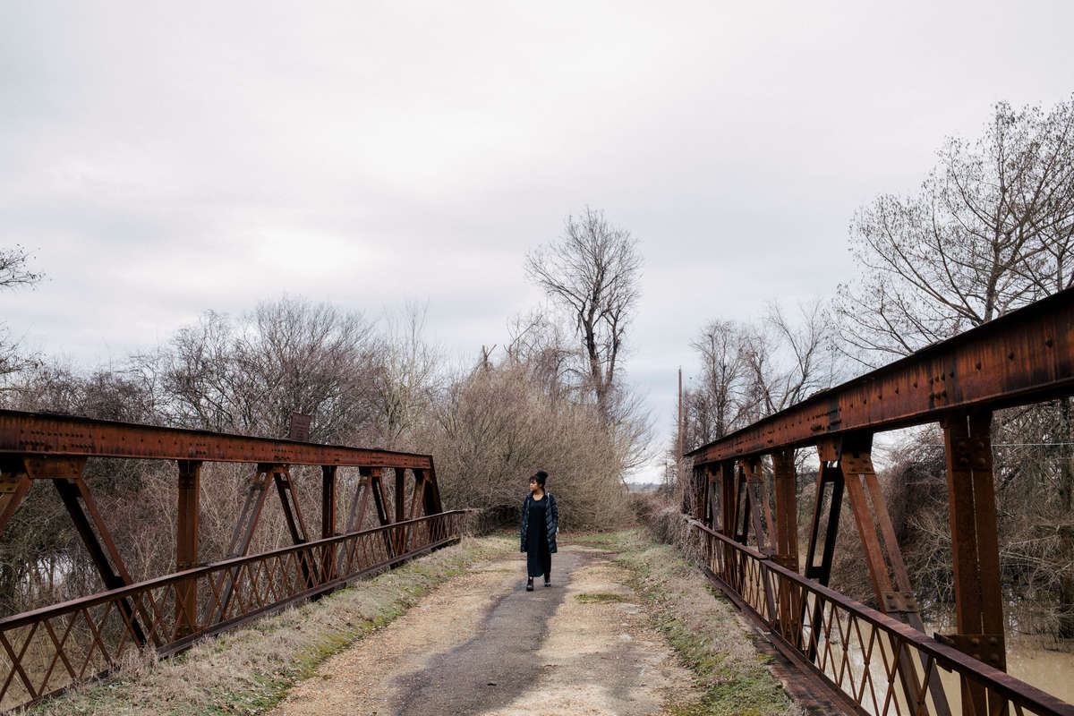 Tiaryn Daniels walks across a bridge at Black Bayou in Glendora, Mississippi. This is where historian Johnny Thomas says Emmett Till’s body was dumped in 1955.