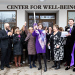 Madonna McDermott, executive director of the Center for Well-Being, cuts a ribbon along with President Julie Sullivan and other administrators, staff, faculty and supporters during the grand opening of the new Center for Well-Being. Mark Brown/University of St. Thomas