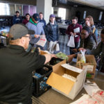 Dining Services staff members hand out perishable food in Scooter’s to students and staff amid the campus shutdown. Mark Brown/University of St. Thomas