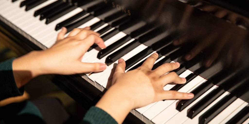 Hands are pictured on keys during a piano class in the Brady Educational Center on November 2, 2018 in St. Paul.