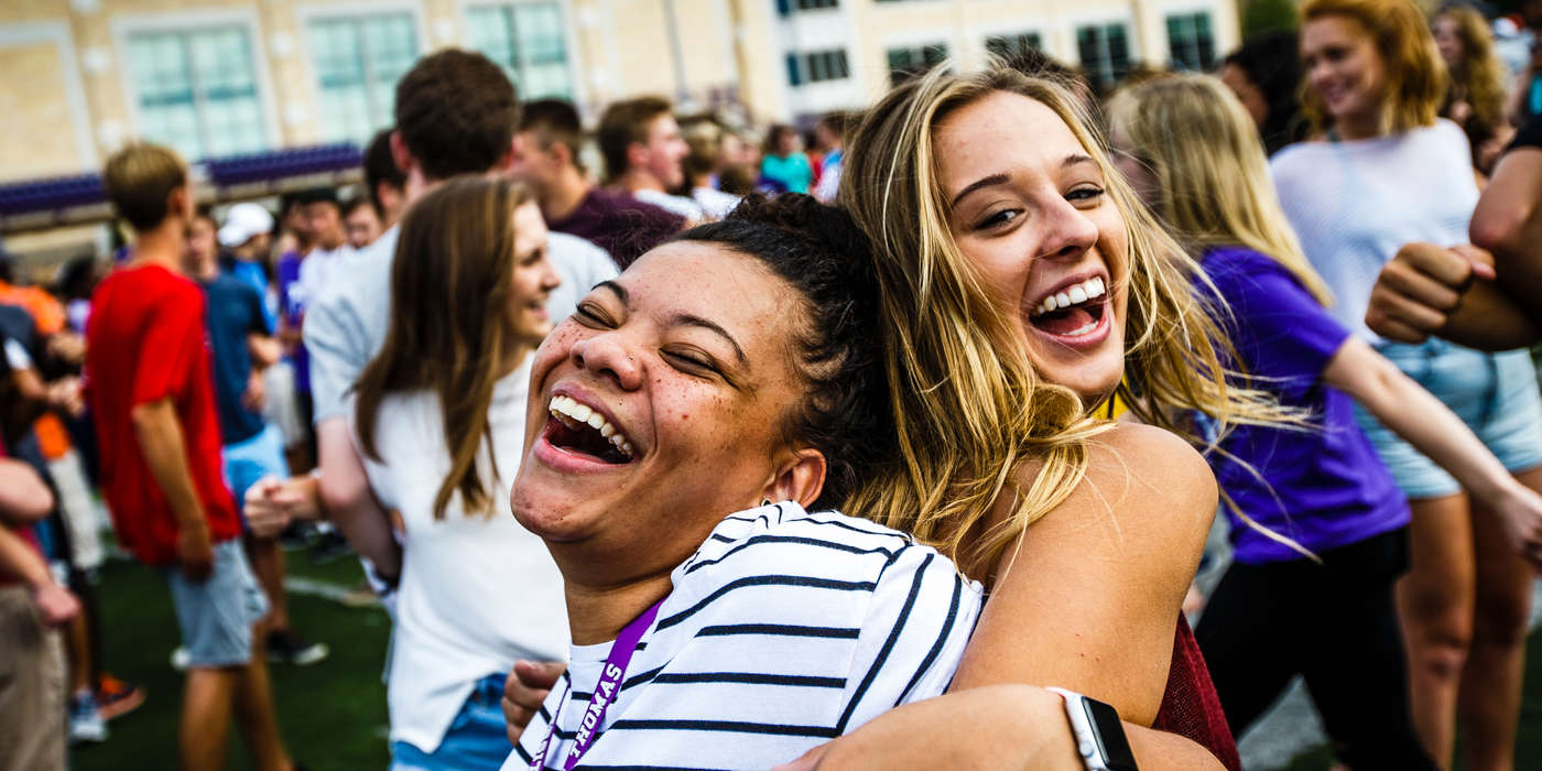 Students, including Kenzie Fannin (left) participate in "The Great Tommie Get-Together," a mass ice breaker activity September 3, 2016 in O'Shaughnessy Stadium as part of Welcome Days.