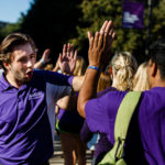 Orientation leader Michael Antolak greets new students during the March Through the Arches event September 8, 2016.