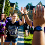Students slap hands with staff during the March Through the Arches event September 8, 2016.