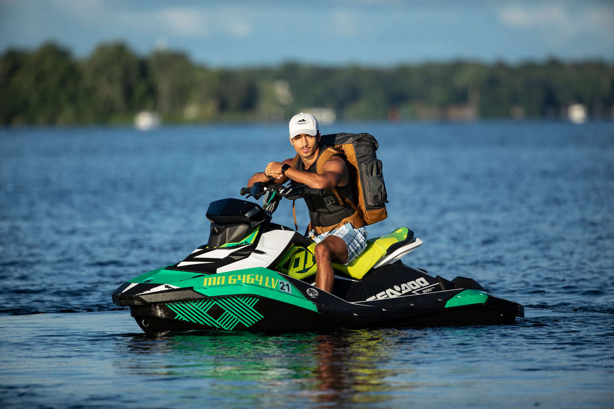 Schulze Innovation Scholar Dylan Dierking founded Foodski, a jet ski food delivery business based in White Bear Lake. Dierking takes orders for deliveries from customers ordering food from area restaurants and delivers them to homes and boats around the lake on his jet ski. Photos taken on July 22, 2020, in White Bear Lake. Dylan Dierking poses for a portrait on his Jet Ski.
