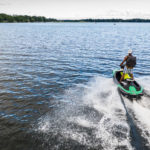 Schulze Innovation Scholar Dylan Dierking founded Foodski, a jet ski food delivery business based in White Bear Lake. Dierking takes orders for deliveries from customers ordering food from area restaurants and delivers them to homes and boats around the lake on his jet ski. Photos taken on July 22, 2020, in White Bear Lake. Dylan Dierking makes a delivery via Jet Ski.