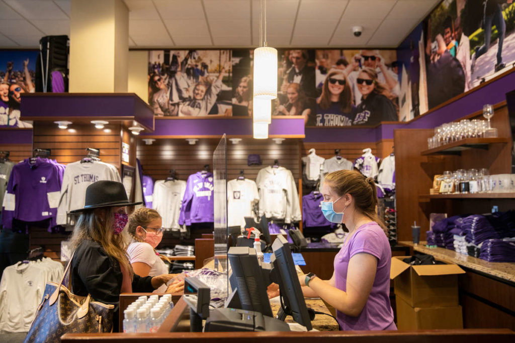 Laura Martino, a junior, helps check out customers of the Tommie Shop in the Anderson Student Center. Liam James Doyle/University of St. Thomas