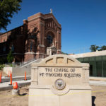 A new location for the Chapel of St. Thomas Aquinas sign in front of the Iversen Center for Faith.