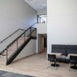 A seating space and stairway in Tommie East Residence Hall.