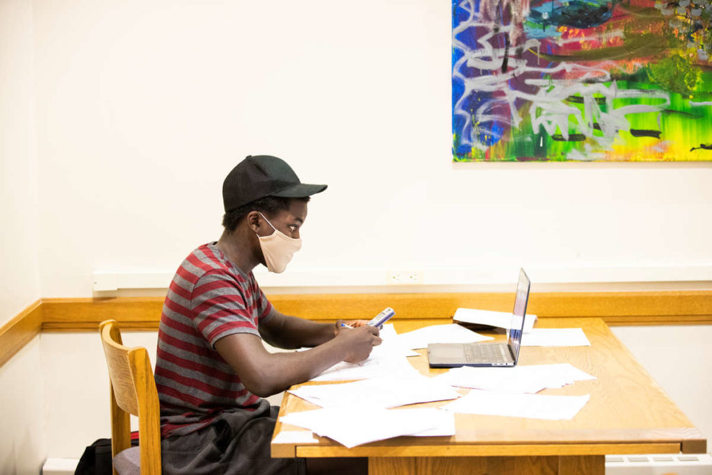 Electrical Engineering student Timothy Nkemba studies calculus while wearing a mask in the O'Shaughnessy Frey Library Center. Mark Brown/University of St. Thomas