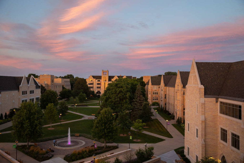 The lower quad, Monahan Plaza, Aquinas Hall and the O'Shaughnessy-Frey Library are pictured under glowing pink skies on a beautiful summer night on July 29, 2020, in St. Paul.