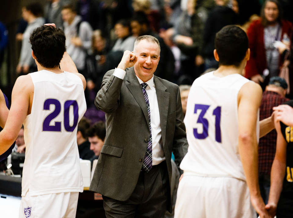 Head coach John Tauer celebrates a victory following a men's basketball game versus Gustavus Adolphus College December 13, 2017 in Schoenecker Arena. The Tommies beat the Gusties 64-51.