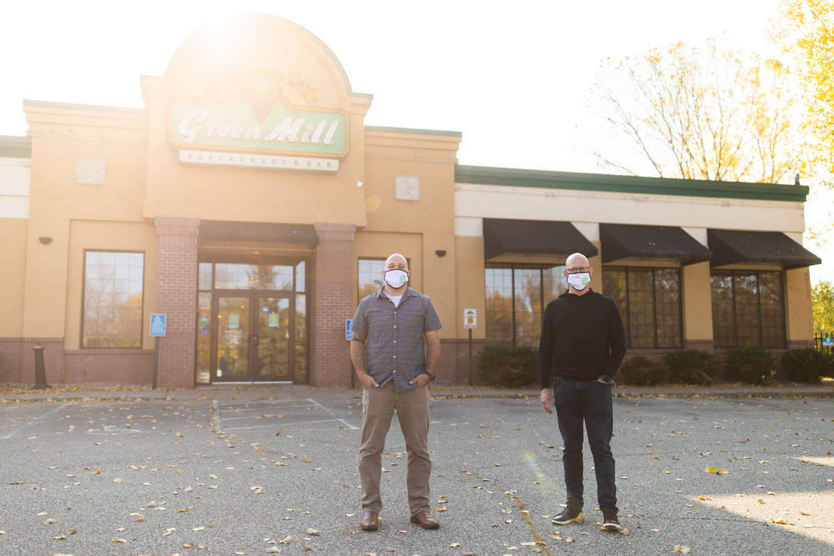 Executive MBA alumni Scott Ceplecha, left, and Matty O’Reilly pose for a portrait outside of a temporarily vacant Green Mill restaurant in Eagan on October 5, 2020. Along with their colleague, Ben Boaz, they have created a new venture, Project 53, a model in which business spaces that have emptied due to the Coronavirus pandemic can be instead used as a remote learning space for students.