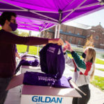 Students pick up their free St. Thomas Homecoming sweatshirts outside of Ireland Hall as a part of Homecoming Week. Liam James Doyle/University of St. Thomas