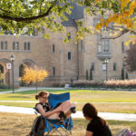 Keeli Gustafson, left, and a friend study below a tree on the lower quad on a beautiful fall afternoon during Homecoming week. Mark Brown/University of St. Thomas