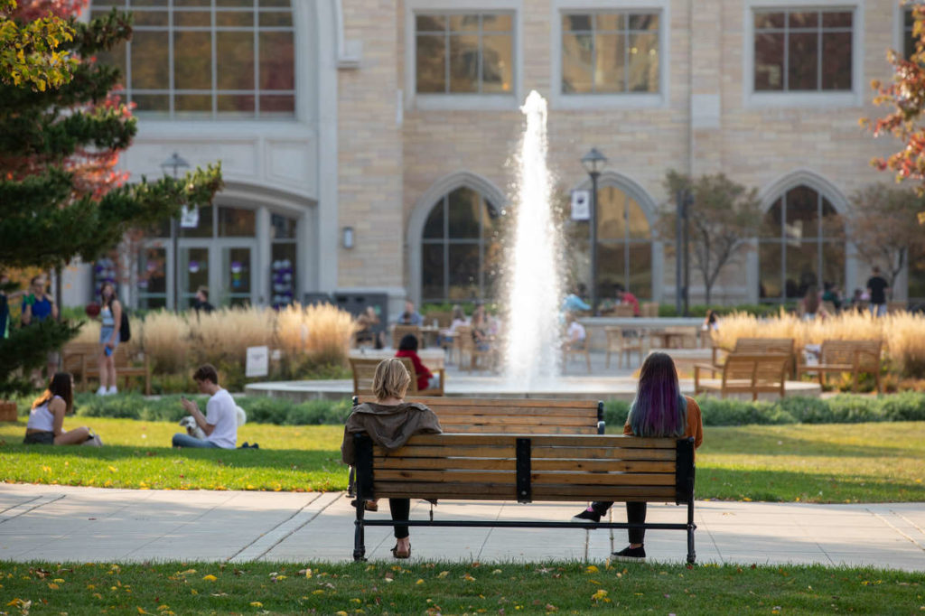 Students hang out on the lower quad on a beautiful fall afternoon during Homecoming week on October 9, 2020, in St. Paul.