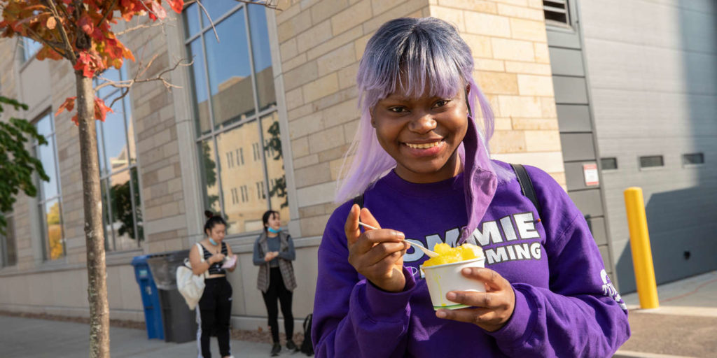 Esberance Mulonda gets a shaved ice at Kurb Side Ice Company food truck on October 9, 2020, in St. Paul. The Food Trucks were on campus as part of 2020 Homecoming celebrations.
