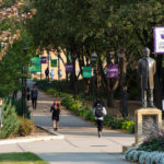 Students walk from the upper quad to the lower quad past on a beautiful fall morning on the St. Paul campus. Mark Brown/