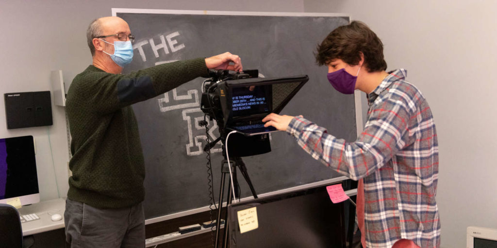 Journalism Professor Mark Neuzil, left, works with Scout Mason, right, in the TommieMedia studio in O'Shaughnessy Education Center on October 29, 2020, in St. Paul.