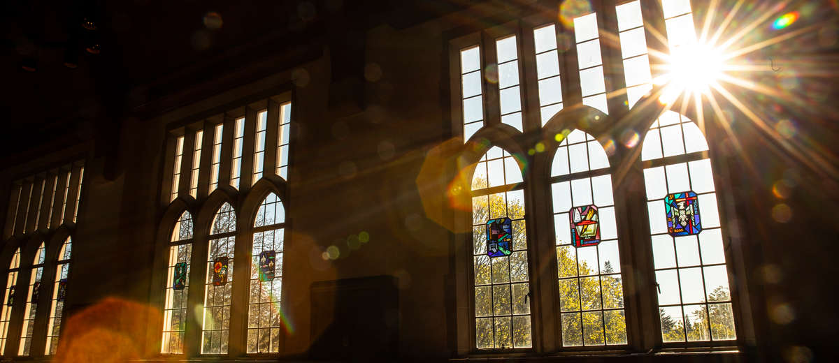 The sun shines through windows in the O’Shaughnessy-Frey Library Center.