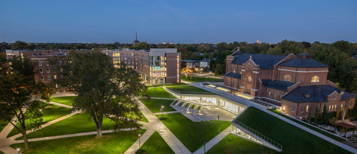 A wide view of the upper quad featuring the Iversen Center for Faith, Aquinas Chapel, Tommie North Residence Hall, and Ireland Hall as photographed at dusk on the rooftop of Brady Hall in St. Paul on September 29, 2020.