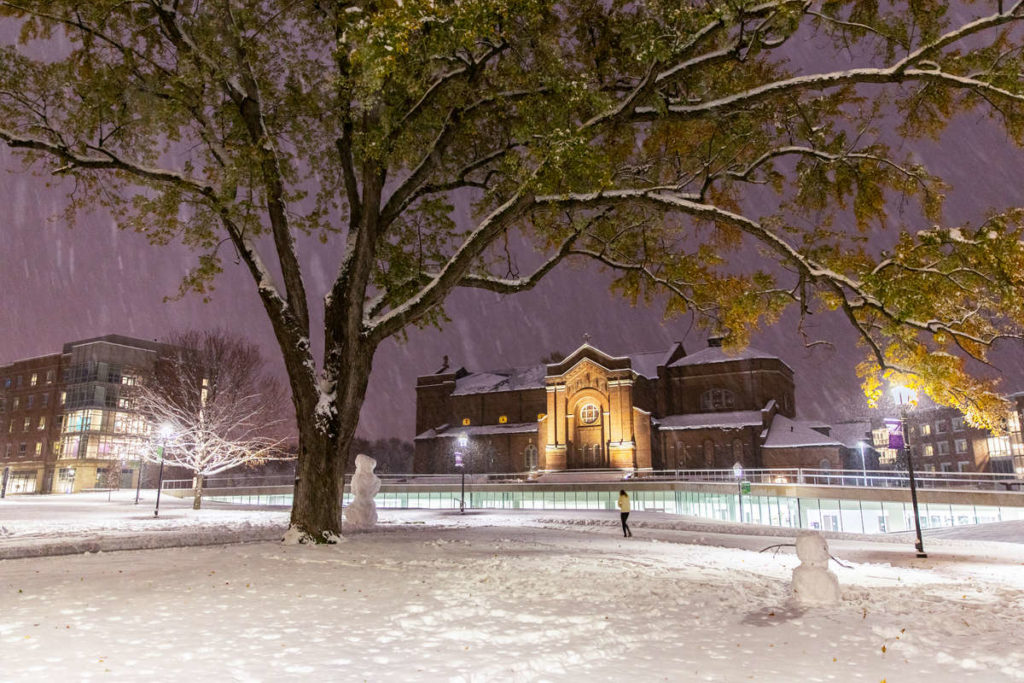 Aquinas Chapel and the Iversen Center for Faith glow at night during the first measurable snowfall of the year on October. Mark Brown/University of St. Thomas