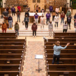 Masked and socially distanced, Angela Mitchell conducts the Donne Unite women’s chorus during a rehearsal inside of the Aquinas Chapel. Liam James Doyle/University of St. Thomas