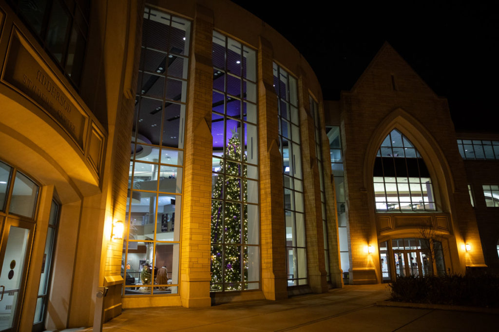 A holiday tree with decorations and lights stands in the Anderson Student Center.
