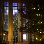 A holiday tree with decorations and lights stands in the Anderson Student Center.
